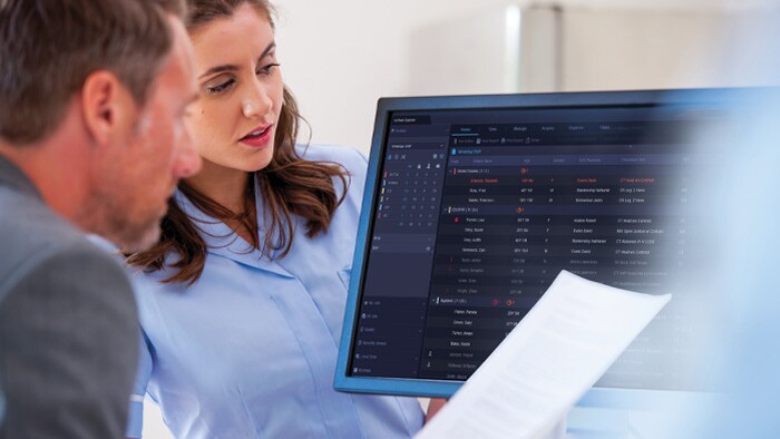 Radiologists checking patient data on a monitor