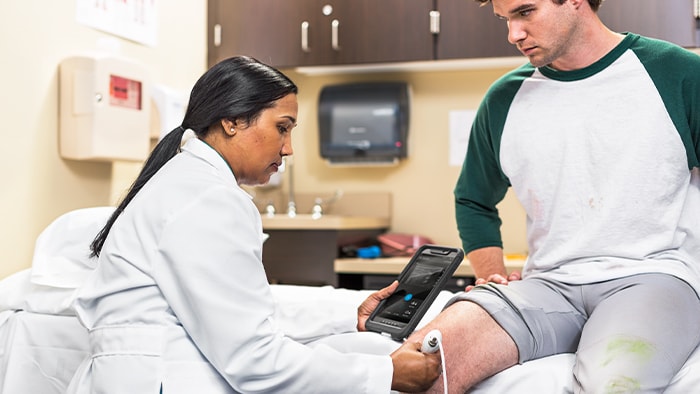 Patient being examined on his knee